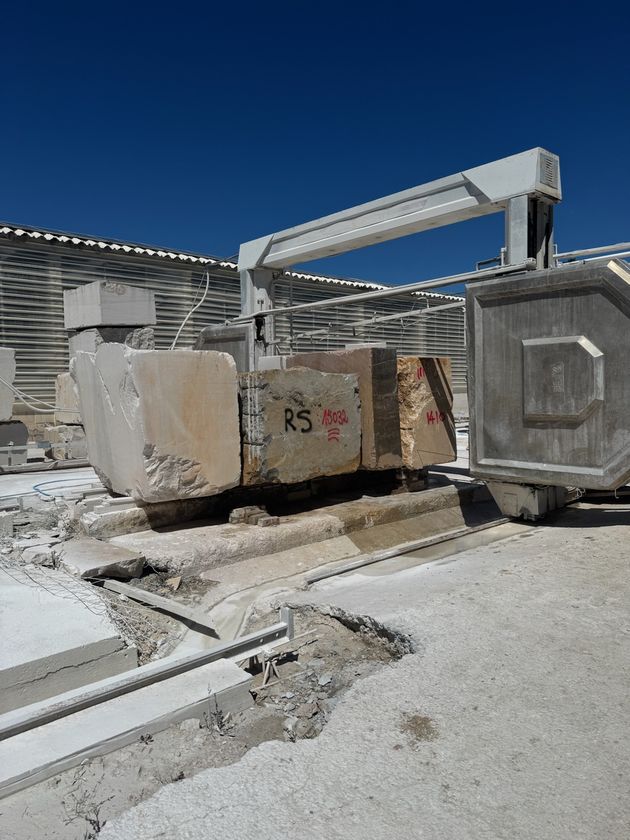 Block saw cutting a marked stone block