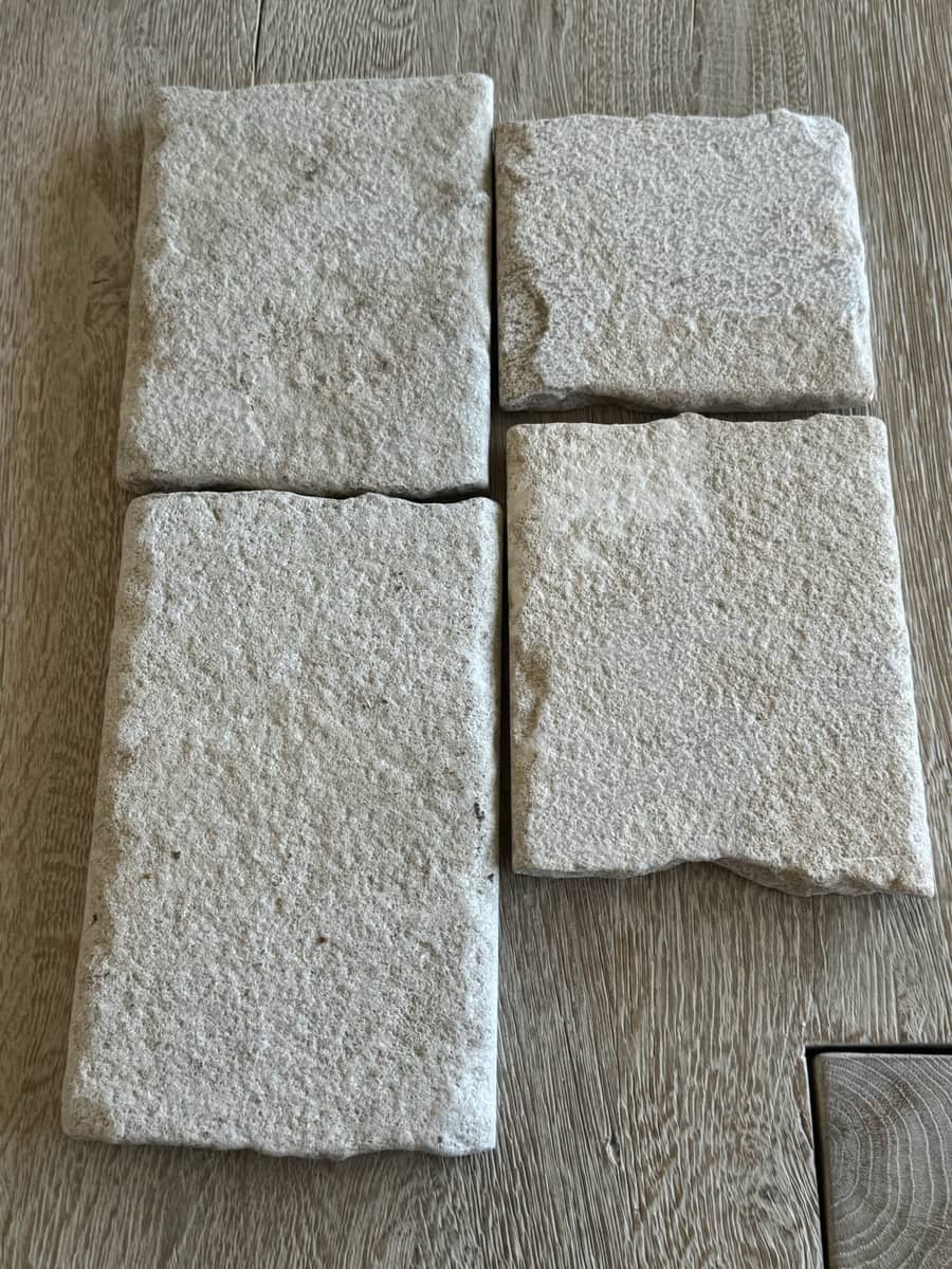 Rough-edged limestone treads on the bench