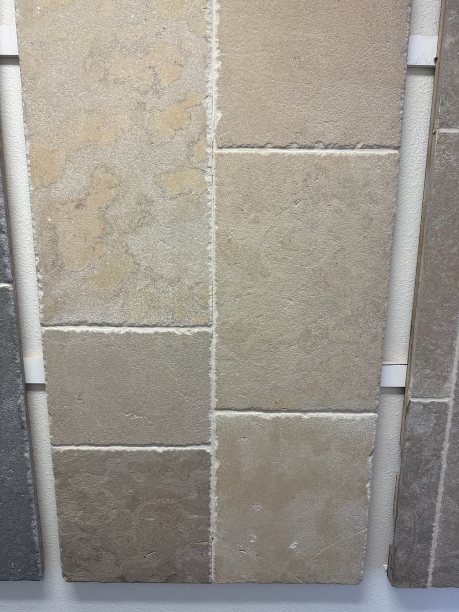 Limestone tile set around rough-in pipework