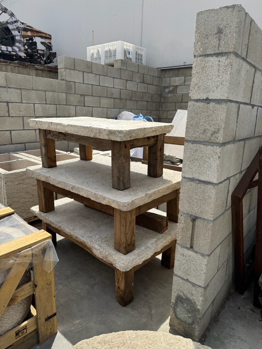 Stone table tops stacked in the yard