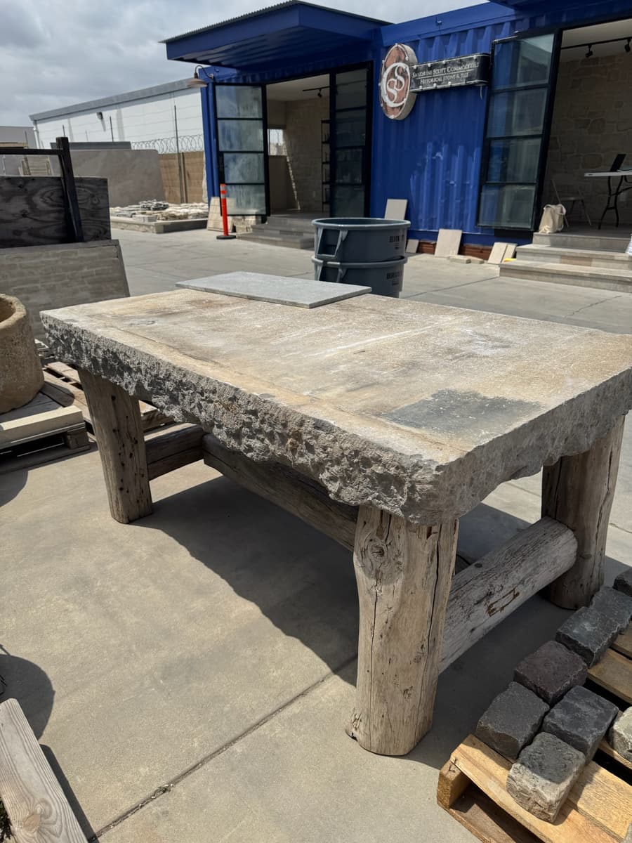 Rough stone table top on timber legs