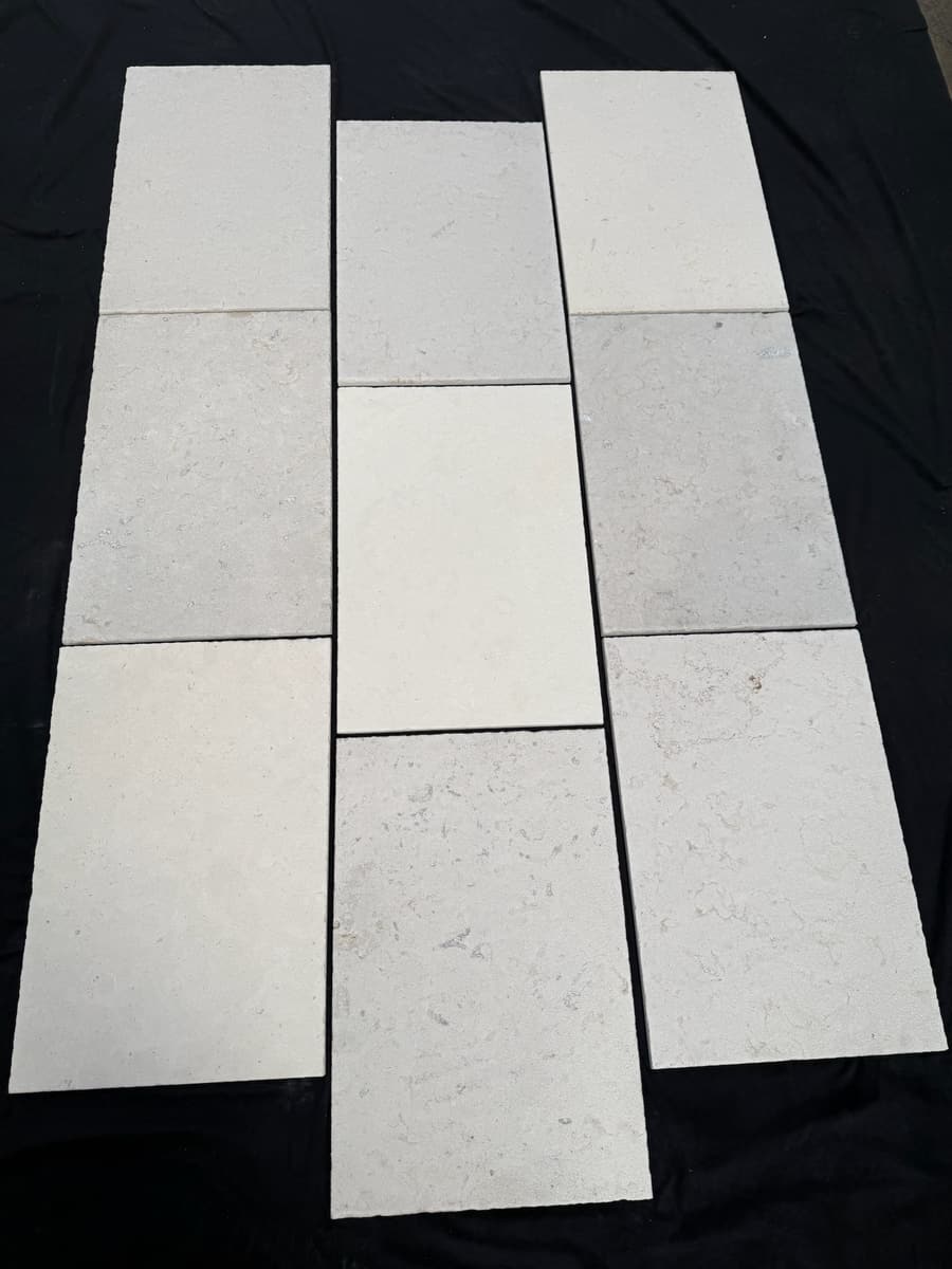 Limestone planks laid out on black